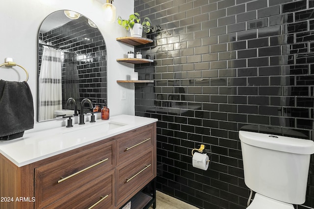 bathroom featuring a shower with shower curtain, vanity, toilet, and tile walls