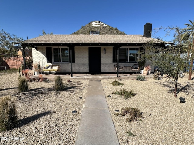 112 W Vogel Ave, Phoenix, AZ 85021 - ranch-style house with brick siding, covered porch, and a chimney