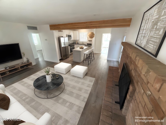 112 W Vogel Ave, Phoenix, AZ 85021 - living area with beamed ceiling, baseboards, a fireplace, and dark wood-style floors
