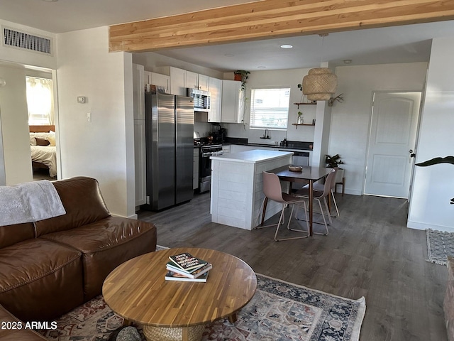 112 W Vogel Ave, Phoenix, AZ 85021 - living room with dark wood-style flooring, baseboards, and beam ceiling