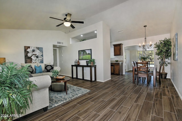 living room with high vaulted ceiling, ceiling fan with notable chandelier, and dark hardwood / wood-style flooring