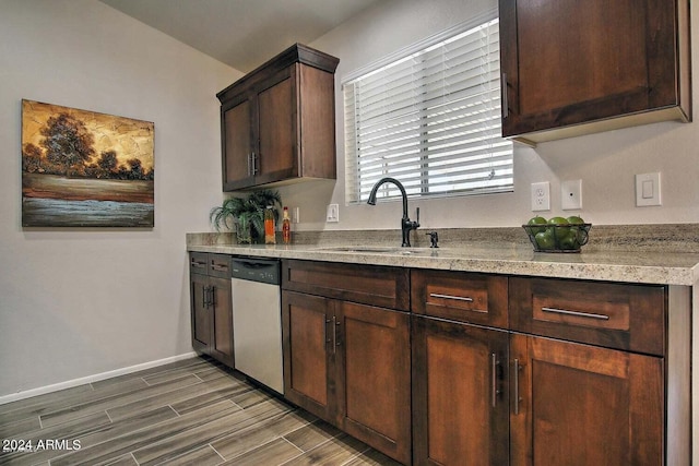 kitchen with dishwasher, dark brown cabinetry, sink, and dark hardwood / wood-style flooring