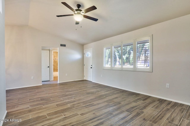 empty room featuring ceiling fan, vaulted ceiling, and hardwood / wood-style floors