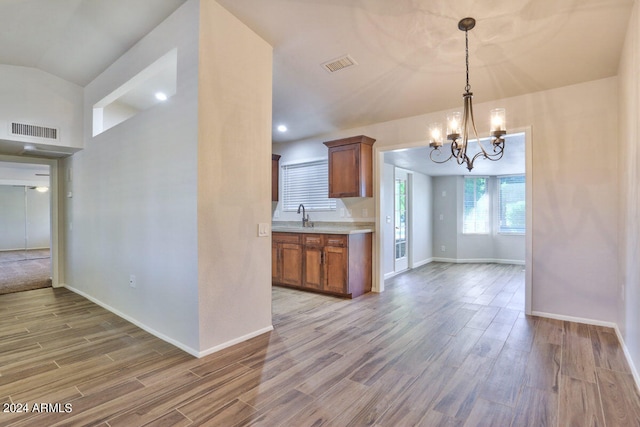 kitchen with pendant lighting, a chandelier, and hardwood / wood-style floors