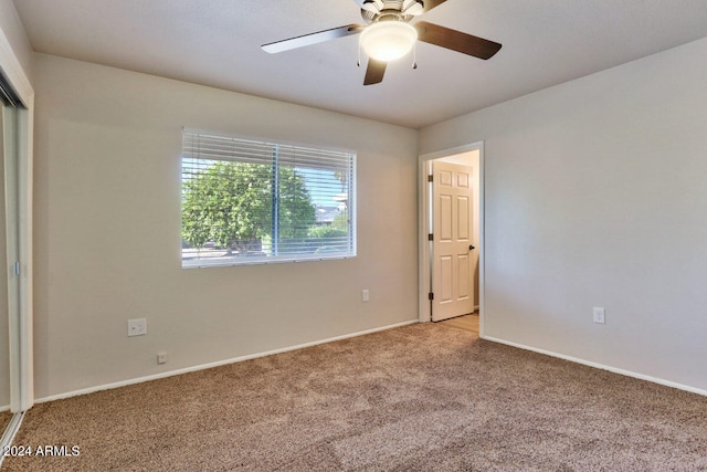 unfurnished bedroom with ceiling fan and light carpet