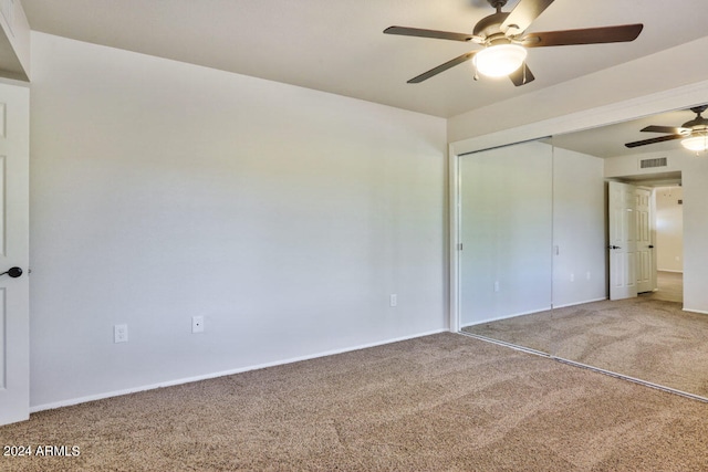 unfurnished bedroom with a closet, carpet floors, and ceiling fan