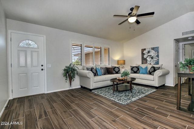 living room featuring dark hardwood / wood-style flooring, ceiling fan, and vaulted ceiling