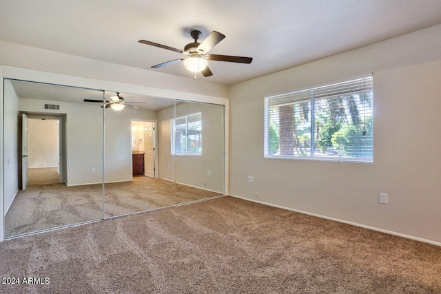 unfurnished bedroom featuring a closet, ceiling fan, connected bathroom, and carpet