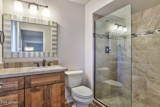 bathroom with vanity, toilet, and an enclosed shower