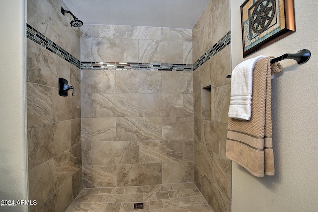 bathroom with tiled shower