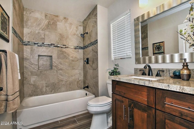 full bathroom with vanity, toilet, and tiled shower / bath