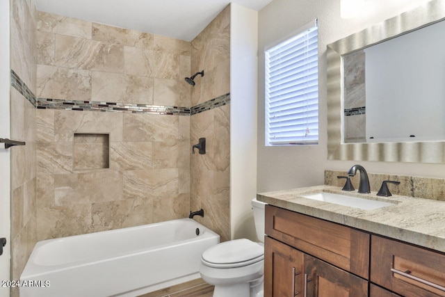 full bathroom featuring vanity, toilet, hardwood / wood-style flooring, and tiled shower / bath combo