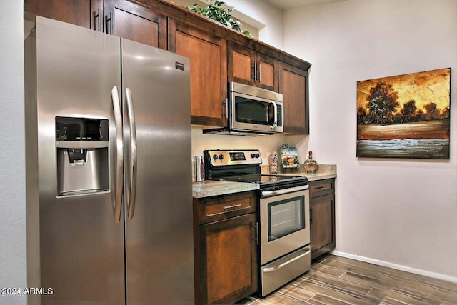 kitchen with dark wood-type flooring and stainless steel appliances