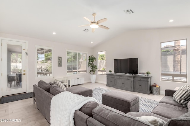 living room featuring radiator heating unit, ceiling fan, vaulted ceiling, light wood-type flooring, and recessed lighting