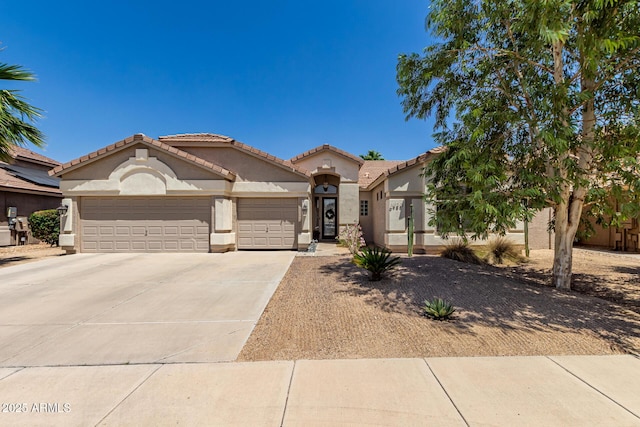 mediterranean / spanish-style home with driveway, stucco siding, an attached garage, and a tile roof