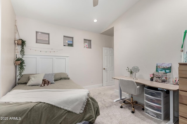 bedroom with vaulted ceiling, a desk, light carpet, baseboards, and ceiling fan
