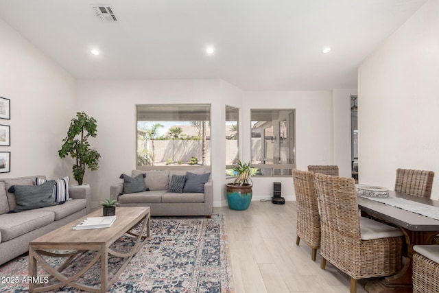 living area with wood finished floors, recessed lighting, and baseboards