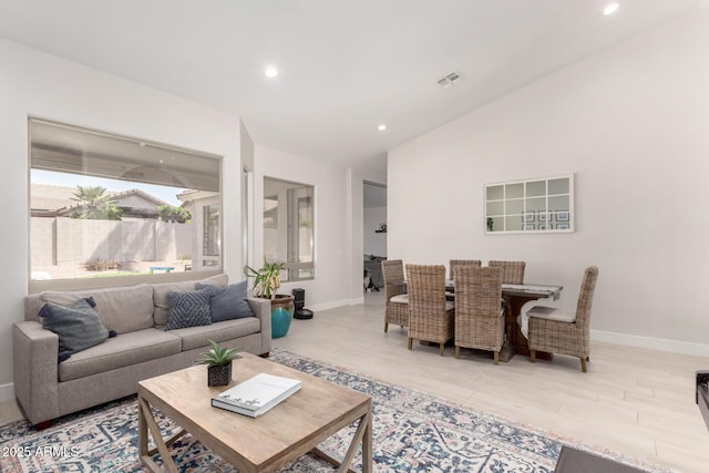 living room with baseboards, recessed lighting, and wood finished floors