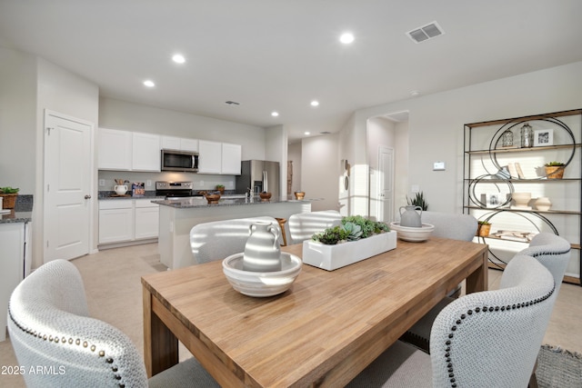 dining space featuring visible vents and recessed lighting