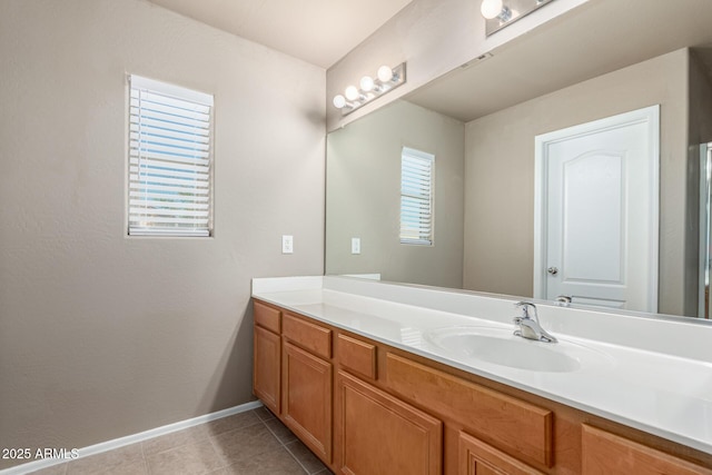 bathroom featuring baseboards, tile patterned floors, and vanity