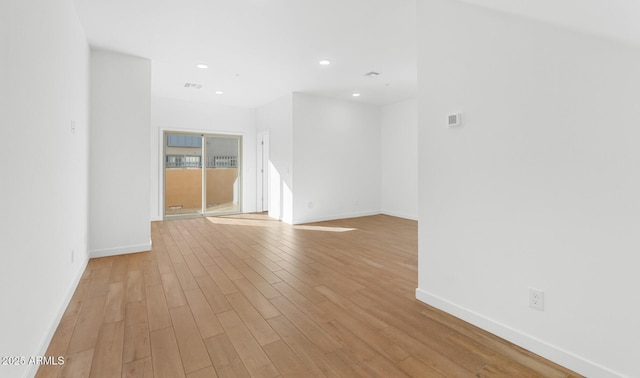 spare room with visible vents, recessed lighting, light wood-type flooring, and baseboards