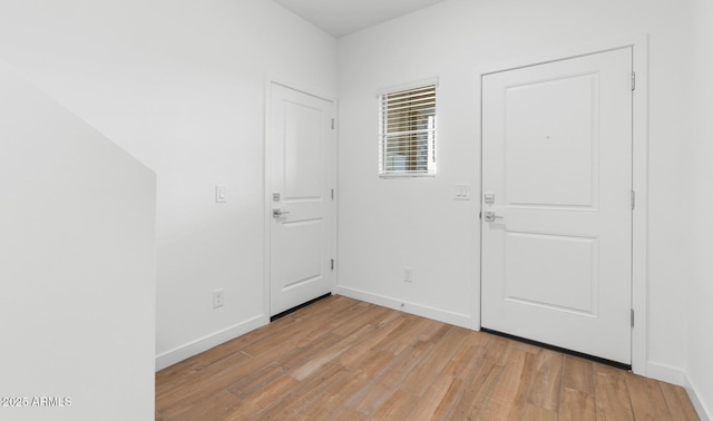 entrance foyer with light wood-style floors and baseboards