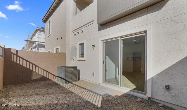 exterior space with central air condition unit and fence