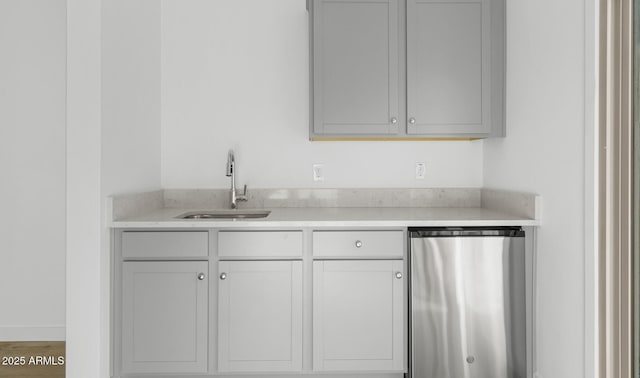 kitchen with dishwashing machine, a sink, light countertops, white cabinets, and fridge