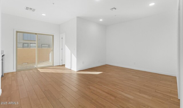 spare room featuring recessed lighting, light wood-style floors, and visible vents