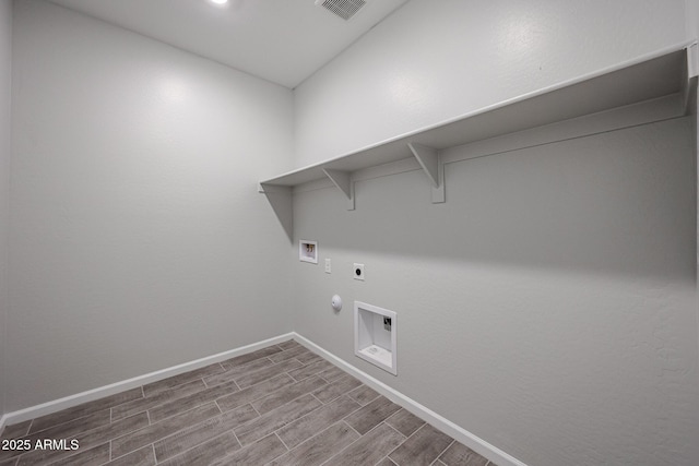 2514 E Music Mountain Ave, Apache Junction, AZ 85119 - laundry area with gas dryer hookup, hookup for an electric dryer, baseboards, washer hookup, and wood finished floors