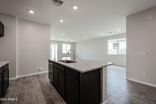 2514 E Music Mountain Ave, Apache Junction, AZ 85119 - kitchen with a sink, wood finish floors, dishwasher, light stone counters, and recessed lighting