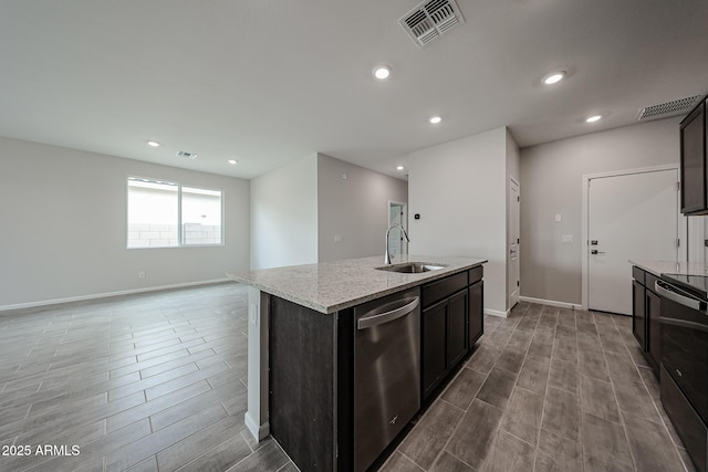 2514 E Music Mountain Ave, Apache Junction, AZ 85119 - kitchen with dishwasher, wood tiled floors, electric range, a sink, and an island with sink