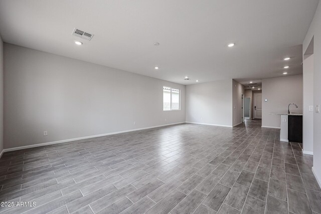 2514 E Music Mountain Ave, Apache Junction, AZ 85119 - empty room with recessed lighting, baseboards, wood finished floors, and a sink