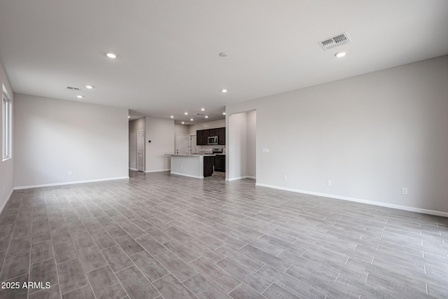 2514 E Music Mountain Ave, Apache Junction, AZ 85119 - unfurnished living room with recessed lighting, baseboards, and light wood-style floors