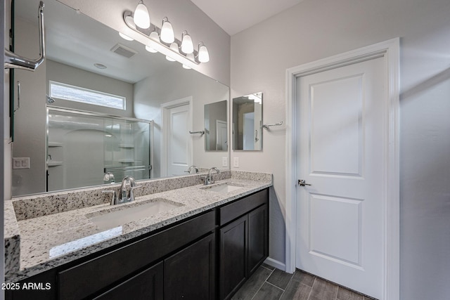 2514 E Music Mountain Ave, Apache Junction, AZ 85119 - bathroom featuring a stall shower, wood finished floors, double vanity, and baseboards