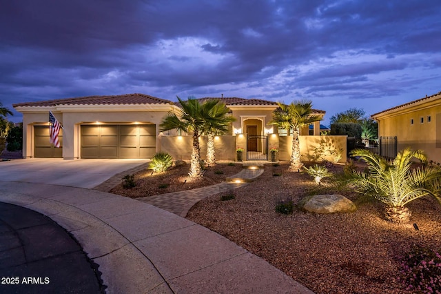 mediterranean / spanish-style home with a garage