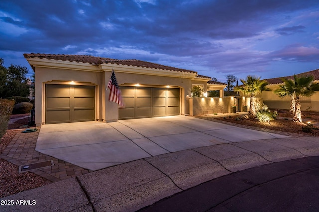 mediterranean / spanish-style house with a garage