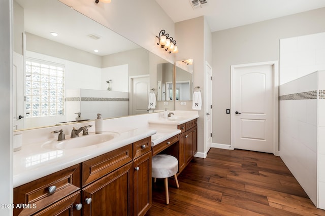 bathroom featuring vanity, hardwood / wood-style floors, and walk in shower