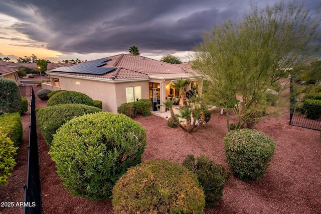 mediterranean / spanish house featuring a patio area and solar panels