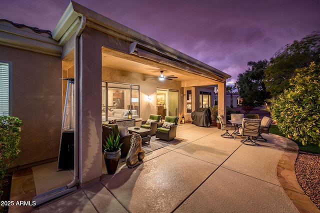 patio terrace at dusk featuring an outdoor living space, a grill, and ceiling fan