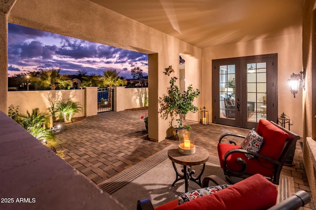 patio terrace at dusk featuring french doors