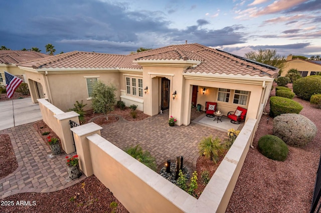 mediterranean / spanish-style house with a patio