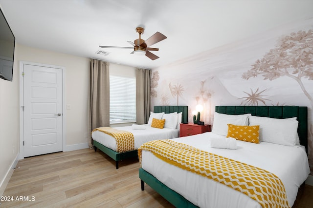 bedroom with visible vents, a ceiling fan, light wood-type flooring, and baseboards