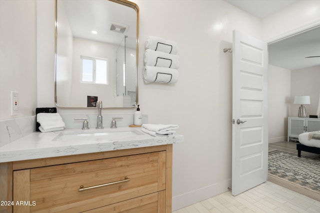 full bath with vanity, baseboards, and wood finished floors