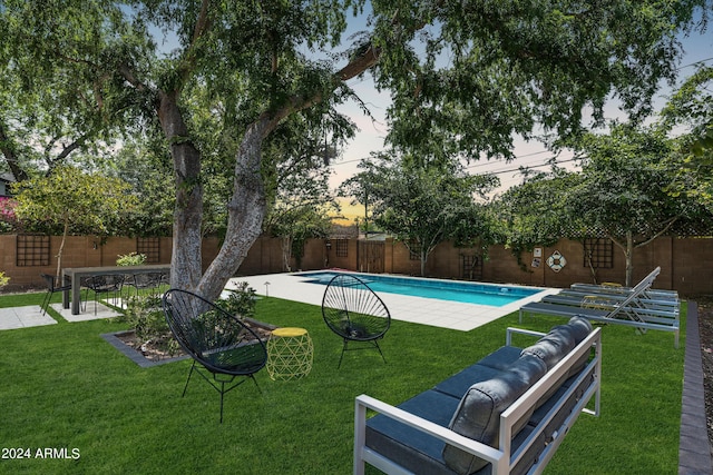 view of swimming pool with a yard, a patio area, a fenced in pool, and a fenced backyard