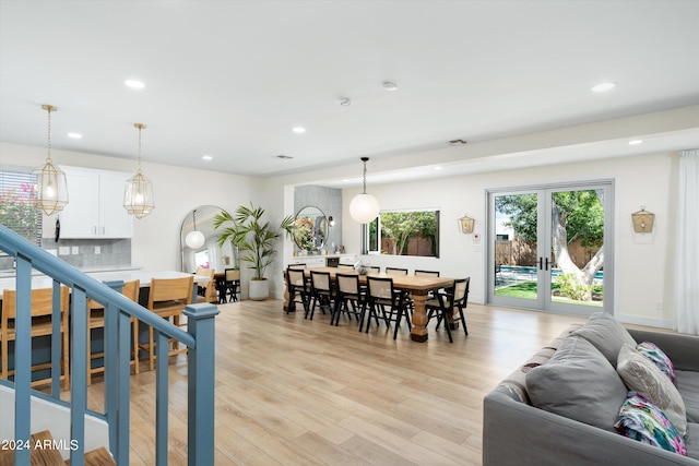 living room with stairway, visible vents, light wood-style flooring, recessed lighting, and french doors