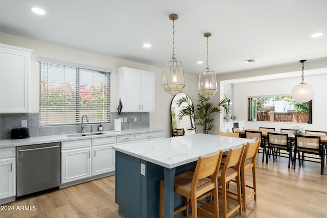 kitchen featuring a sink, white cabinetry, dishwasher, and light wood finished floors