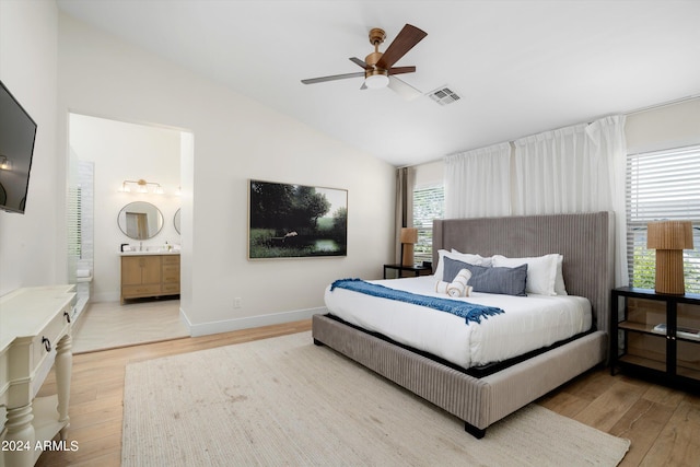 bedroom with visible vents, baseboards, light wood-type flooring, and lofted ceiling