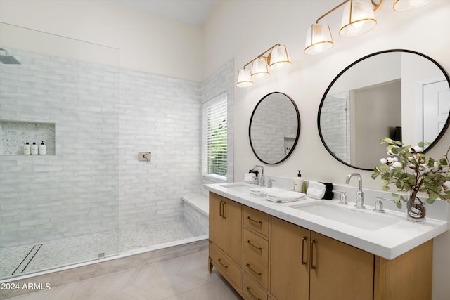 bathroom featuring a sink, walk in shower, and double vanity