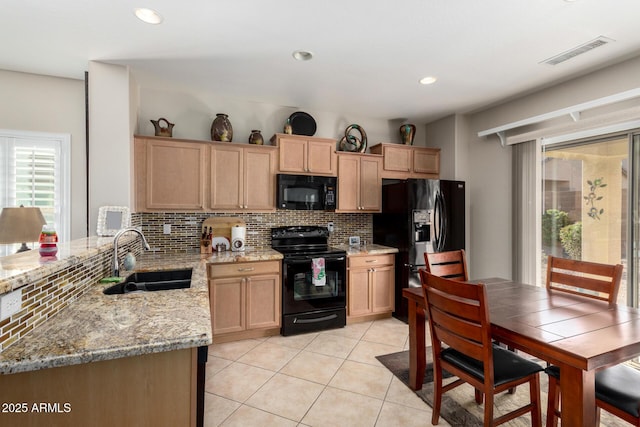 kitchen featuring black appliances, sink, decorative backsplash, light stone countertops, and light tile patterned flooring